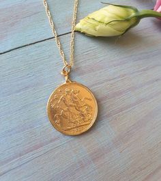 This coin pendant necklace was 100% handmade. The pendant is made of a Moroccan gold coin to which I designed with a vintage inspired fashion. The necklace is 14k gold filled chain with a 14k gold plated coin pendant. It is also available in sterling silver. Dimensions: The 14k gold necklace is available in multiple lengths. The antique coin pendent's diameter is 2.1 cm (0.8 inches) This Gold coin necklace is delicate unique and beautiful for daily wear. To see other necklaces I make: https://ww Vintage Coin-shaped Gold Plated Jewelry, Vintage Gold Medallion Necklace Tarnish Resistant, Vintage Yellow Gold Tarnish Resistant Medallion Necklace, Vintage Yellow Gold Tarnish-resistant Medallion Necklace, Vintage Tarnish Resistant Medallion Necklace, Classic Gold Pendant Coin Necklace, Classic Gold Coin Necklace With Round Pendant, Classic Gold Necklace With Coin Pendant, Classic Charm Necklace With Coin Medallion