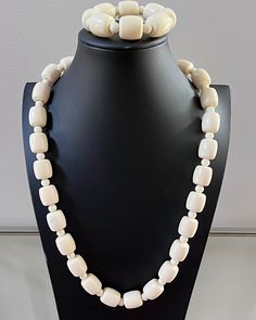 This is a traditional West African off-white beaded necklace. These jewelry pieces are unisex and are designed to be worn by adults Beads are made of resin Length ( from neck to chest): 14 inches *** Each Necklace comes with a matching bracelet These beaded jewelry is an integral part of West African culture. Traditionally it is worn by Royalty, Chiefs, and those who are part of the Royal households among many kingdoms in West Africa. It is also worn by brides and grooms during their wedding cer White Wooden Beads Jewelry, Adjustable Single Strand Cream Jewelry, White Wooden Beaded Jewelry, Vintage White Hand-strung Necklaces, Vintage White Hand-strung Jewelry, Adjustable White Wooden Beads, Elegant White Jewelry With Wooden Beads, White Large Beads Costume Jewelry, Adjustable Bone Colored Beaded Jewelry