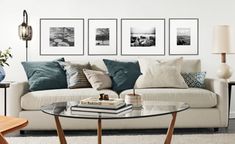 a living room filled with lots of furniture and pictures on the wall above it's coffee table