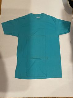 Selling a Vintage 90s Hanes Light Blue Blank Single Stitch Tee Shirt Made in USA - Large. It is fitted for men and size large. The brand is Hanes. It is a vintage piece most likely from the 1990s, made in the USA, and single stitch. Really cool color way, great piece to customize. Lightly stained from age as seen in photos. Sold as is. 90s Style Blue Relaxed Fit Top, 90s Blue Crew Neck Top, 90s Style Pre-shrunk Short Sleeve Shirt, 90s Style Blue Shirt For Streetwear, 90s Style Blue Streetwear Shirt, Vintage Blue Crew Neck Shirt, 90s Blue Short Sleeve T-shirt, 90s Style Blue Short Sleeve T-shirt, 90s Style Blue Relaxed Fit Shirt