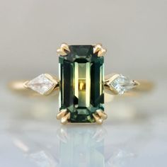 emerald cut green sapphire engagement ring