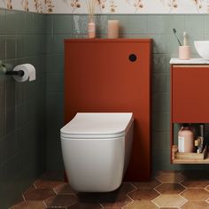 a white toilet sitting next to a red cabinet in a bathroom