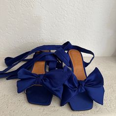 Royal Blue Satin Sandals With Bows Blue Evening Sandals For Summer, Blue Evening Sandals For Spring, Blue Flat Heel Sandals For Formal Occasions, Blue Formal Sandals With Flat Heel, Formal Blue Sandals With Flat Heel, Blue Sandals With Wrapped Heel For Summer, Blue Sandals With Wrapped Block Heel, Blue Flat Sandals For Formal Occasions, Elegant Blue Flat Heel Sandals