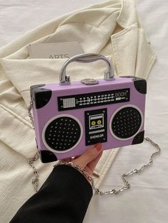 Introducing the Radiant Melody: Purple Radio Handbag, a trendy music-inspired crossbody bag. With its stylish design and convenient crossbody strap, this bag is perfect for carrying all your essentials while adding a touch of music to your outfit. Made from high-quality materials, it is both durable and fashionable. Elevate your fashion game with this must-have accessory. Color : Purple Details : Chain, Spiked Type : Novelty Bag, Square Bag, Box Bag, Camera Bag Bag Size : Mini Closure Type : Buc Trendy Portable Purple Shoulder Bag, Trendy Rectangular Shoulder Bag For Concert, Trendy Rectangular Shoulder Bag For Concerts, Trendy Rectangular Bag For Concerts, Trendy Shoulder Bag For Concerts, Retro Crossbody Box Bag With Adjustable Strap, Retro Portable Crossbody Shoulder Bag, Portable Retro Crossbody Shoulder Bag, Retro Crossbody Bag