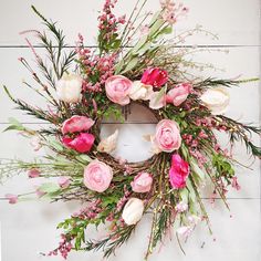 a wreath with pink and white flowers on it