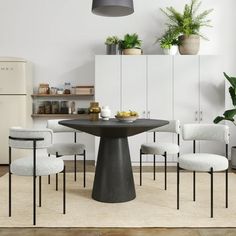 a dining room table with four chairs around it