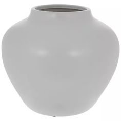 a large white vase sitting on top of a table