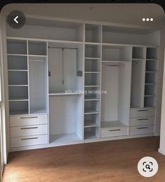 an empty room with white cabinets and drawers