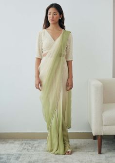 Elevate your attire effortlessly with this pre-stitched sari. It features a pleated wrap skirt in georgette with an attached organza drape, adorned with a beaded scalloped border and pleat detailing. The set comes with an ivory beaded blouse with elegant elbow-length sleeves. The sari is designed for comfort and convenience with adjustable hook-eye closures at the waist. Embrace a quietly romantic look that's versatile and fuss-free. Festive Draped Chiffon Saree, Elegant Summer Pre-draped Saree With Dupatta, Summer Traditional Georgette Pre-draped Saree, Green Organza Pre-draped Saree Traditional, Green Organza Pre-draped Saree, Summer Traditional Drape Pre-draped Georgette Saree, Summer Pre-draped Georgette Saree With Sheer Dupatta, Elegant Silk Chiffon Pre-draped Saree, Pista Green Pre-draped Saree For Eid