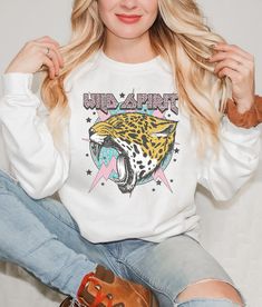 Add this Wild Spirit sweatshirt to your trendy wardrobe this season. This preppy sweater is slightly distressed and oversized with a rock and roll aesthetic. * Ultra soft * Distressed design * Pre-shrunk * Universal fit * True to size * DTG Printing * Brand - Gildan Refunds/Exchanges: * No Cancellations * No returns/exchanges * All sales are final Sizing: Our graphic tees and sweatshirts are a true to size standard unisex fit. For an oversized look, please size up. For a TShirt dress fit, we recommend sizing up at least two sizes. Please oversee the sizing chart provided in the listing photos to ensure your measurements are correct as we DO NOT offer cancellations, exchanges or returns. Shipping: All products are made to order and are usually ready to ship within 2-7 business days. Please