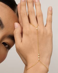 Break away from basic bracelets and amp up your look with this hand chain from wrist to finger. The subtly sweet and dainty chain meets premium AAAAA Cubic Zirconia stones for simple sophistication in your everyday outfits. Measurements: 14K yellow gold plated and rhodium plated. The ring portion measures 2.75 inches, the middle chain is 4.7 inches, and the bracelet is 5 inches with a 2.5-inch extender. 2.5mm premium AAAAA Cubic Zirconia. Basic Bracelets, Basic Bracelet, High Support Bra, Finger Bracelets, Hand Chain Bracelet, Cubic Zirconia Bracelet, Chunky Jewelry, Dainty Chain, Toggle Bracelet