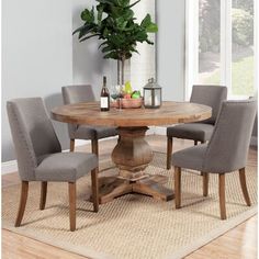 a dining room table with four chairs around it