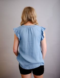 Ruffle sleeve chambray woven top. This denim look without the weight of true denim. Fun for summer! Raegan is wearing her normal size small. Fit is true to size. Relaxed Fit Washed Tencel Tops, Chic Everyday Denim Top, Summer Linen Tops With Frayed Hem, Spring Linen Tops With Frayed Hem, Spring Tops With Frayed Hem For Casual Gatherings, Relaxed Fit Denim Top For Day Out, Trendy Light Wash Top For Casual Gatherings, Light-colored Trendy Tops For Casual Gatherings, Denim Ruffled Short Sleeve Tops