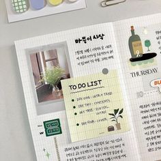 an open planner with stickers and magnets attached to the pages in korean language