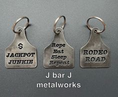 three metal tags with words on them