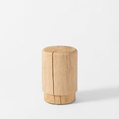 a small wooden object sitting on top of a white surface with no one around it