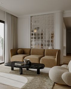 a living room filled with furniture next to a sliding glass door that looks out onto the water