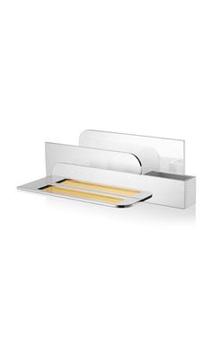 a white bathroom shelf with two trays on it