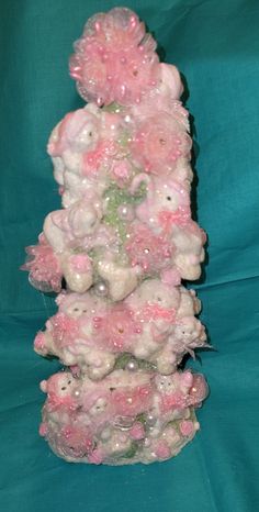 there is a pink and white christmas tree made out of fake snow flakes on a blue background