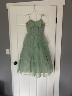 "1950's light green tiered ruffle party dress with big bow and spaghetti straps. Not in perfect condition - has several stains, one on the skirt and both underarms. Both underarms are also extremely ripped. Could use a long soak! See all photos, being sold as is Women's XXS 31\" bust 23\" waist free hips 40.5\" shoulder to hem (strap to bottom of last tier)" Red Velvet Shirt, Dress With Big Bow, Fair Outfits, Velvet Shirt, Most Beautiful Dresses, Big Bow, Dress Clothes For Women, Vintage 1950s, Light Green