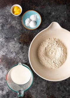 two bowls with flour and eggs next to them