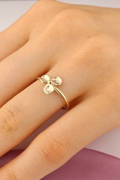 Our 14k Solid Gold Three Leaf Clover Ring is a stunning piece that captures the essence of nature's beauty. Crafted from solid gold, this ring exudes a sense of elegance and sophistication. The three leaf clover design adds a touch of whimsy and symbolism, making it a meaningful accessory to wear. The golden hue of the ring complements all skin tones, adding a warm glow to your hand. The intricate details of the leaves bring the design to life, showcasing the craftsmanship and attention to detail that went into creating this exquisite piece of jewelry. Perfect for both formal occasions and everyday wear, this ring is versatile and timeless. It can be stacked with other rings or worn on its own as a statement piece. Our 14k Solid Gold Three Leaf Clover Ring is a truly special piece that wil Symbol Jewelry, Three Leaf Clover, Clover Ring, Lucky Symbols, Clover Design, Charm Ring, Symbolic Jewelry, Charm Rings, Leaf Clover