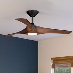 a ceiling fan in a bedroom with blue walls