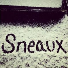 the word sneaux written in black ink on snow