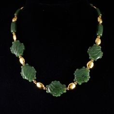 "Beautiful top quality nephrite jade \"stone\" glyph beads strung with golden vermeil beads (24k gold on sterling silver) with a hammered finish.  You will not find an item like this .. of this quality .. for this price .. anywhere! 20\" with vermeil s hook clasp ... this stunning necklace comes in a plush jaguar print drawstring bag. The Maya and Aztec considered green a sacred color, they attached special value to green things ... even small slivers of jade were polished and perforated for suspension, and large pieces were carved in the shape of human faces, animals, or... shaped like a hand. This item comes from my Maya and Aztec inspired line of unique jade jewelry: http://www.michaelgoard.com/jade.htm" Aztec Stone, Jaguar Print, Green Things, Nephrite Jade, S Hook, Green A, Jade Jewelry, Jade Stone, Hook Clasp