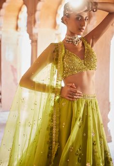 Radiate vibrance in this lime green organza lehenga set, adorned with hand block printed motifs and delicate sequin embroidery that adds a touch of elegance. The fully embellished blouse complements the ensemble beautifully, and the dupatta features a pleated organza trim, enhancing the overall charm of this outfit. Embrace the fusion of traditional artistry and modern aesthetics with this captivating attire. Green Organza Lehenga, Block Print Lehenga, Indian Wedding Dress Traditional, Pleated Organza, Organza Lehenga, Green Lehenga, Vacuum Storage, Indian Wedding Wear, Traditional Indian Wedding