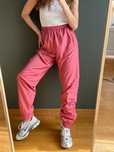 Vintage y2k sport style training trousers in pink, made of polyamide, waterproof, fits S-L, perfect condition waist 73 cm hips 106 cm length 109 cm model's height 166 cm Casual Pink Nylon Pants, Pink Parachute Pants With Elastic Waistband For Streetwear, Pink Parachute Pants For Streetwear, Pink Nylon Casual Parachute Pants, Pink Nylon Pants With Pockets, Pink Stretch Parachute Pants With Pockets, Pink Nylon Bottoms With Elastic Waistband, Casual Pink Nylon Bottoms, Pink Stretch Parachute Pants With Elastic Waistband