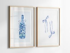 two framed pictures with blue and white designs on them hanging on the wall next to each other