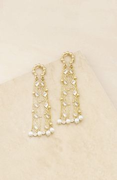 These beaded frontal hoop earrings are strung with cubic zirconia and imitation pearls that move with you. 3 1/4" drop 18k-gold plate/cubic zirconia/acrylic imitation pearl Imported Elegant Pearl Earrings For Reception, Gold Pearl Earrings With Dangling Beads For Party, Elegant Beaded Pearl Earrings For Festive Occasions, Elegant Pearl Drop Chandelier Earrings For Reception, Elegant Festive Beaded Chandelier Earrings, Gold Pearl Embellished Chandelier Drop Earrings, Pearl Drop Earrings For Reception, Gold Jeweled Bridal Earrings For Reception, Elegant Beaded Chandbali Earrings