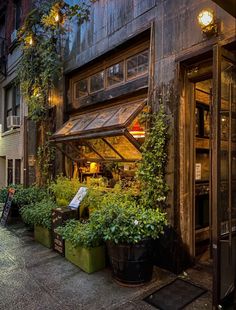 an old building with lots of plants growing out of it