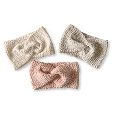 three crocheted headbands, one with a knot on the top and one with