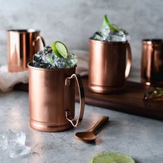 two copper mugs filled with ice and lime slices