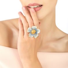 Ideal for those who love statement jewellery with added sparkle. Perfect pairing to the 'Pansy' earring and necklace.This large pansy cocktail ring is adorned with sparkling cubic zirconia, with graduated shades of blue through to white on the petals and vibrant yellow at its centre, made in a three dimensional style for added interest, which will add a touch of sophisticated style to any outfit. Pansies are used to symbolize loving feelings. You can give a pansy flower to just about anyone whom Yellow Pansy, Pansy Flower, Blue Ring, Pansies Flowers, Statement Jewellery, Blue Rings, Ring Gold, Independent Designers Fashion, Cocktail Ring