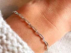 Dainty paperclip chain bracelet - perfect worn on its own, or layered with other bracelets.  Available in multiple sizes and finished with a solid sterling silver lobster clasp. Bracelet arrives packaged in a beautiful Stardust and Silver box, perfect for gifting or for storing your precious treasures.  Find our matching necklace here: https://www.etsy.com/uk/listing/855653307/sterling-silver-paperclip-necklace D E T A I L S  - Material: 925 Sterling Silver. Kind to skin, nickel free and hypoall Silver Adjustable Paperclip Bracelet With Delicate Chain, Adjustable Silver Paperclip Bracelet With Delicate Chain, Silver Paperclip Bracelet With Delicate Adjustable Chain, Everyday Silver Paperclip Bracelet With Delicate Chain, Minimalist Sterling Silver Bracelet With Paperclip Chain, Dainty Sterling Silver Link Paperclip Bracelet, Sterling Silver Cable Chain Bracelet With Rectangular Links, Silver Paperclip Bracelet With Delicate Chain, Minimalist Silver Paperclip Bracelet With Delicate Chain