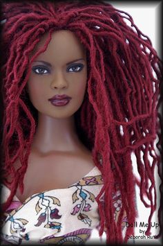 a doll with red dreadlocks on her head