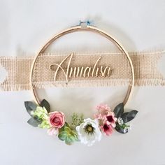 an embroidered name sign with flowers on it