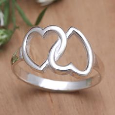 Two interlocking hearts are twice as nice. Presented by Komang Budiarta this charming cocktail ring is perfect for the true romantic. Balinese artisans use sterling silver to create the slender band hand crafting an openwork heart motif that shines in a polished finish. Silver Heart Ring For Mother's Day Promise, Silver Heart Ring For Wedding On Mother's Day, Silver Heart Cut Ring For Anniversary, Silver Heart Cut Ring For Anniversary Gift, Heart-shaped Sterling Silver Ring For Anniversary, Silver Heart Ring For Anniversary Mother's Day, Silver Heart Ring For Anniversary, Mother's Day, Silver Couple Rings For Valentine's Day, Silver Couple Promise Rings For Mother's Day