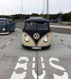 an old vw bus driving down the street