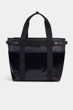 a black tote bag with straps on the front and side, in an open position