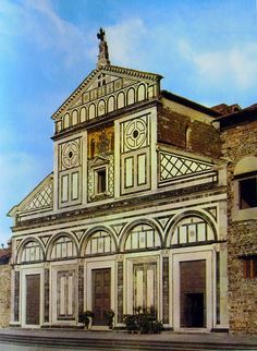 an old building with a statue on top of it