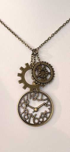 Cool see through outline pocket watch clock with gears Steampunk pendant necklace.  In antique gold/bronze finish.   Chain is approximately 18 inches long with lobster claw clasp.  If you would like a longer or shorter chain, please message me. Clock With Gears, Steampunk Pocket Watch, Steampunk Pendant, Watch Gears, Watch Clock, Steampunk Jewelry, Bronze Finish, Lobster Claw, Antique Bronze