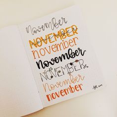 an open notebook with the words november and november written in cursive writing on it