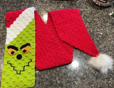 two crocheted christmas stockings sitting on top of a counter next to each other