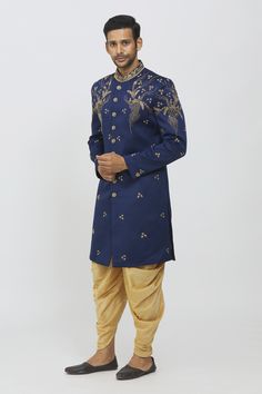 Blue sherwani with gold sequin and cutdana embroidered floral motifs. Comes with gold patiala pant.
Components:2
Pattern:Embroidery
Type of Work:Sequin and Cutdana
Neckline:Mandarin Collar
Sleeve Type:Long
Fabric:TR and Art Silk
Color:Blue
Other Details:
Elasticated waistband
Button detailing on the sleeve hems
Closure: Button front
Occasion:Sangeet - Aza Fashions Semi-stitched Sets With Gold Embroidery And Traditional Drape, Semi-stitched Kurta With Gold Embroidery For Festivals, Festive Gold Embroidered Straight Kurta Salwar Kameez, Blue Kurta With Gold Embroidery For Diwali, Festive Unstitched Suit With Gold Embroidery For Diwali, Traditional Drape Sets With Gold Embroidery, Eid Kundan Sets With Gold Embroidery, Unstitched Salwar Kameez With Gold Embroidery For Festivals, Festive Straight Kurta Salwar Kameez With Gold Embroidery