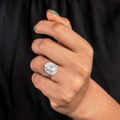 a woman's hand with a diamond ring on it