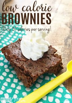 a close up of a piece of brownie on a table with a yellow spoon